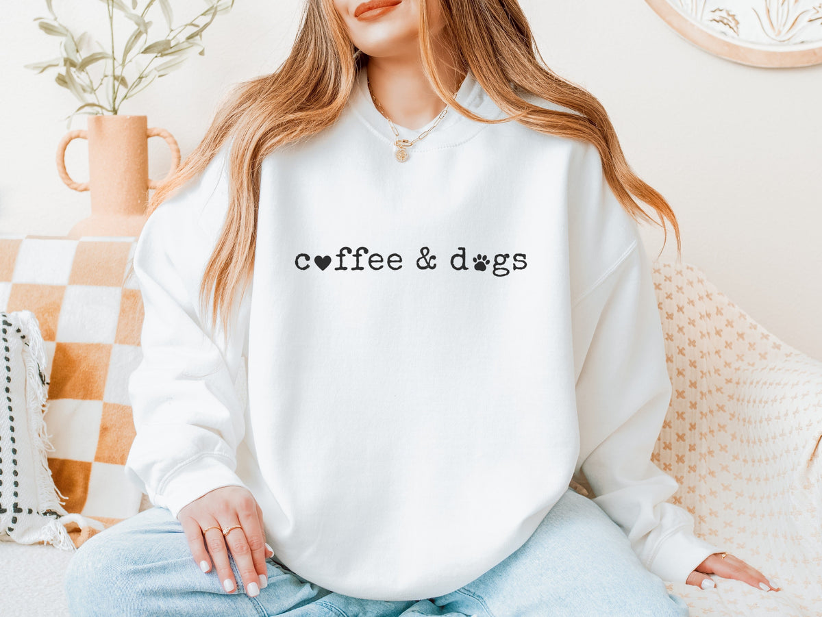 Woman wearing a white coffee & dogs sweatshirt