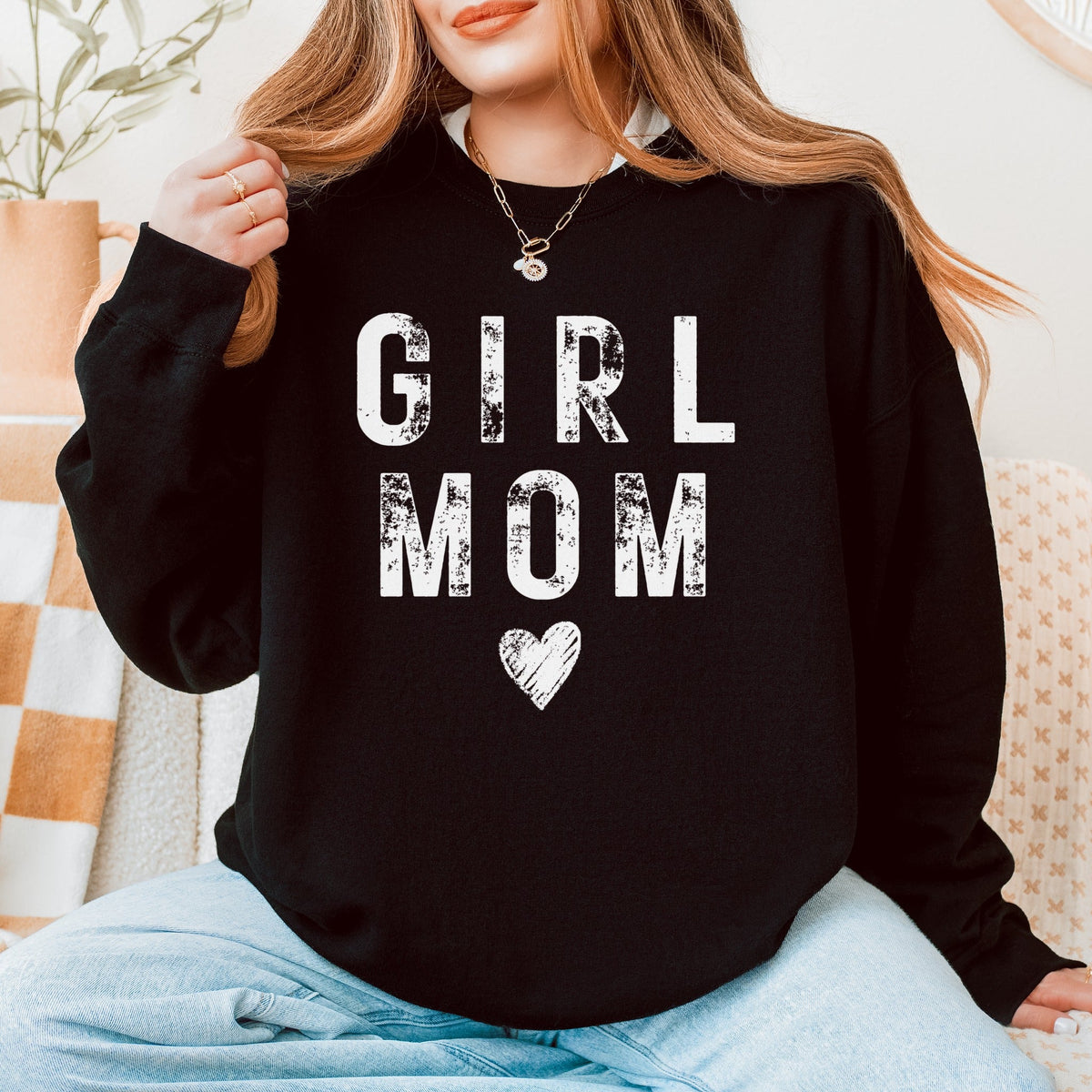 Woman wearing a black Girl Mom sweatshirt