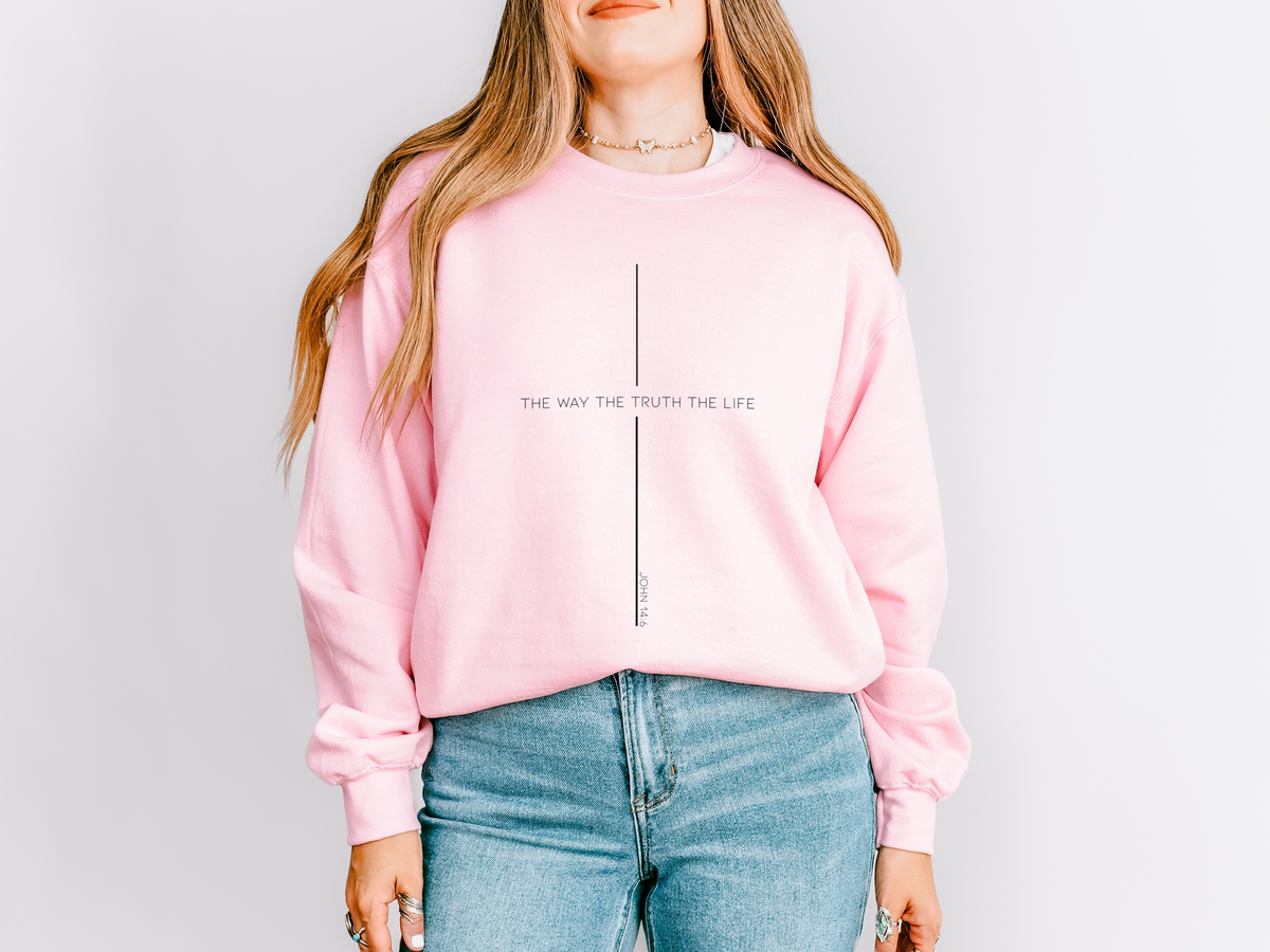 Pink crewneck sweatshirt with a minimalist cross made from the words The Way The Truth The Life