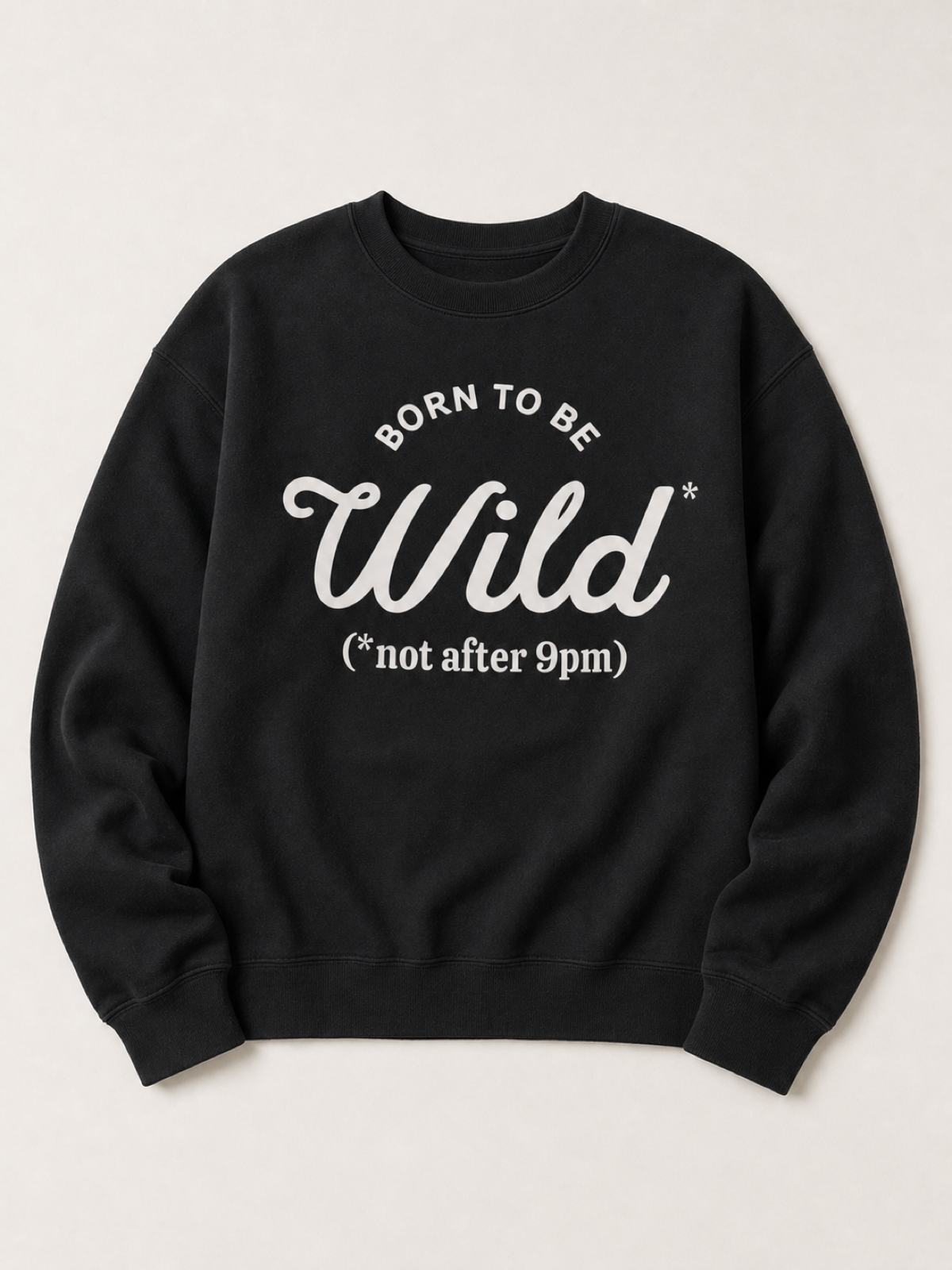 Black crewneck sweatshirt flat lay reading Born To Be Wild, not after 9pm