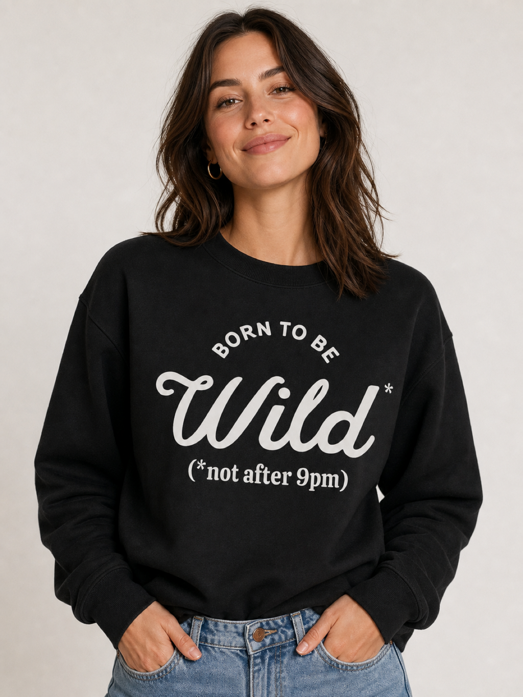 Woman wearing a black crewneck sweatshirt that reads Born To Be Wild, not after 9pm