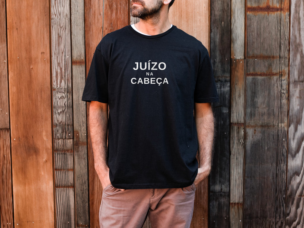 Man wearing a black Juízo na Cabeça t-shirt